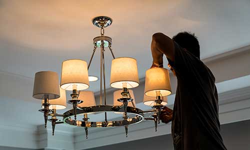 Electrician fixing light.