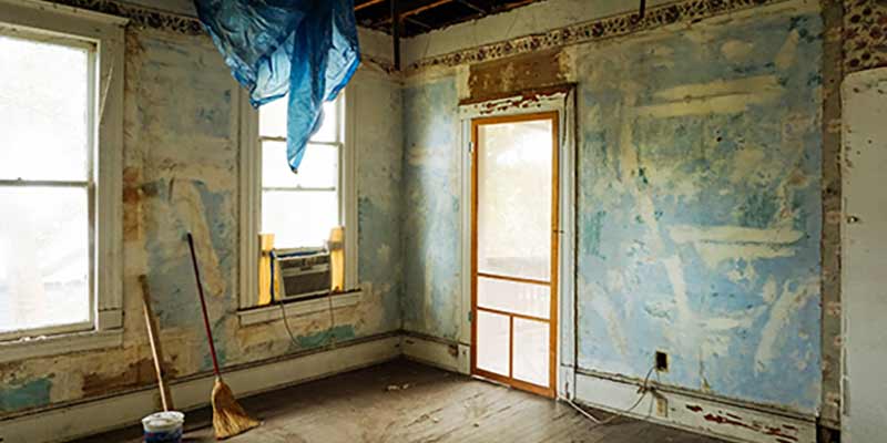 Image of room in house, with walls stripped ready for renovation.